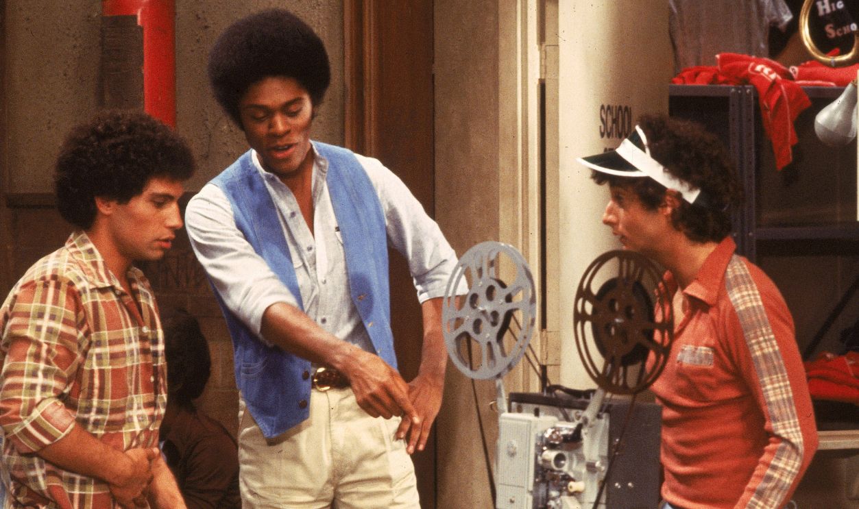 L-R: 'Sweathogs' Robert Hegyes, Lawrence Hilton-Jacobs and Ron Palillo examine a film projector in a still from the television series, 'Welcome Back Kotter,' circa 1977. 