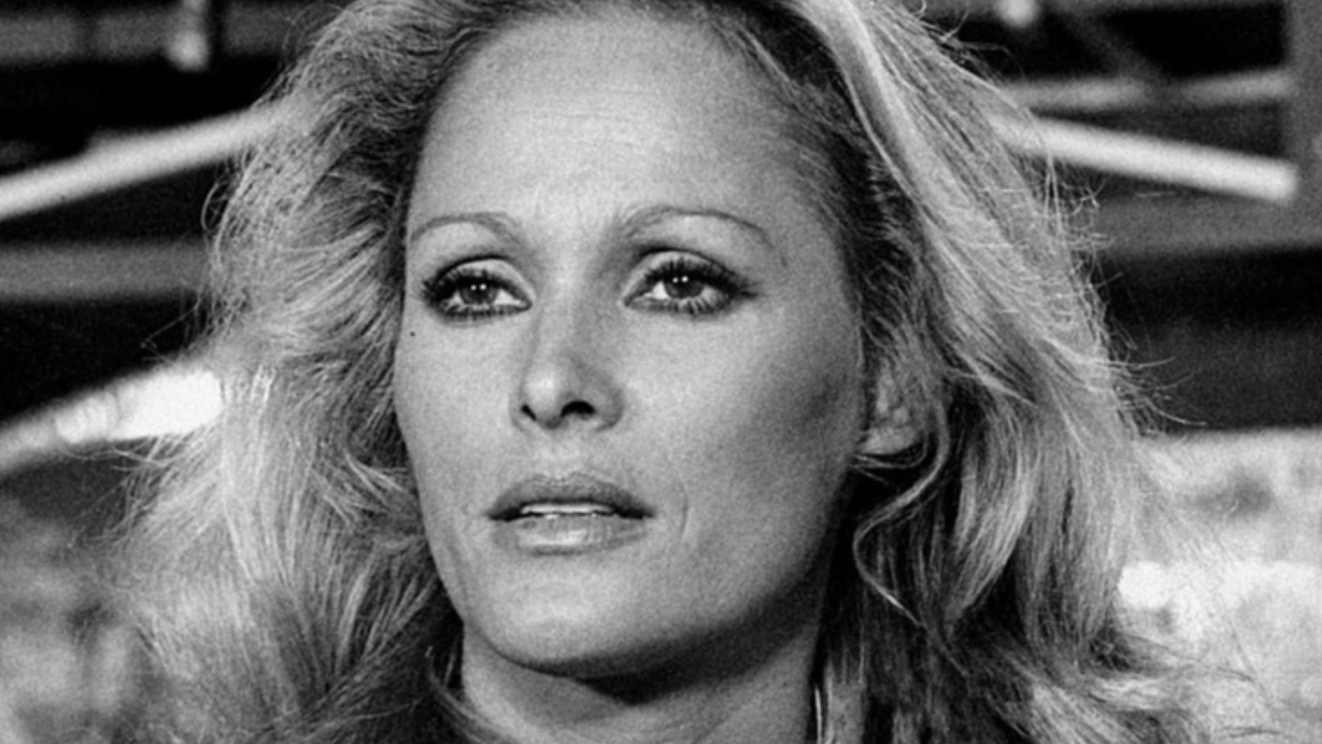 Close-up of Ursula Andress in a scene from the movie Stick'em Up, Darlings, starring the actress as the American hostess Nora Green. Italy, 1974