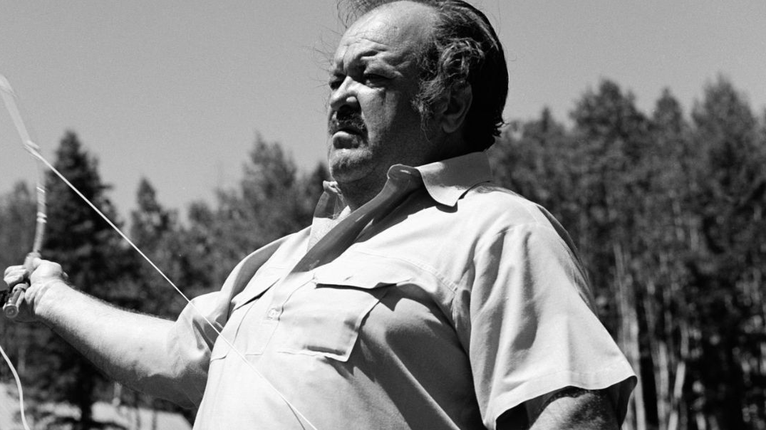 American actor William Conrad (1920 - 1994) casts a line with a fishing rod in a scene from an episode of the television drama 'Cannon' entitled 'Sky Above, Death Below,' California, July 28, 1972. The episode was originally broadcast on September 20, 197