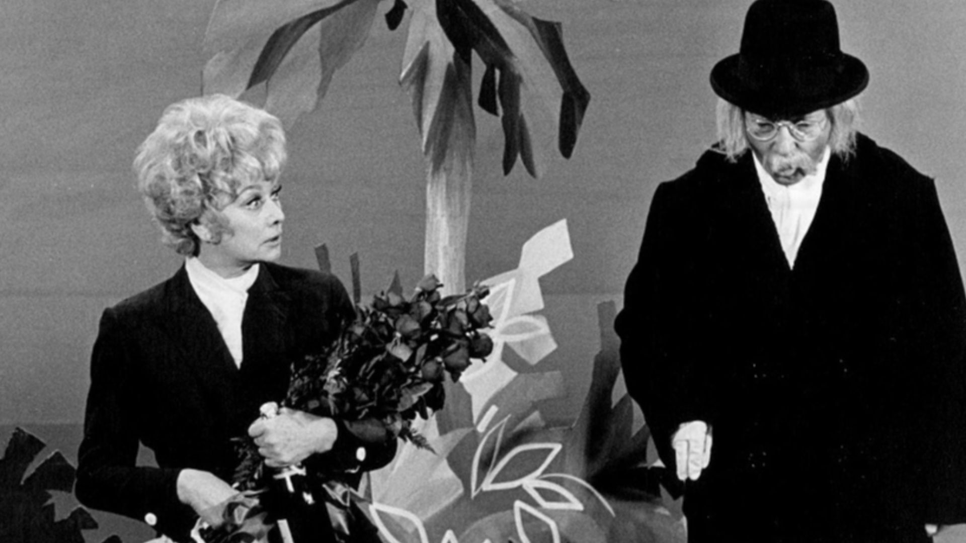 Photo of Lucille Ball and Arte Johnson.  Johnson brings his Laugh-In character of