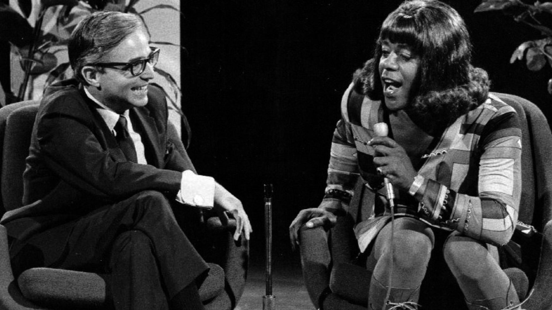 Publicity photo of Flip Wilson as Geraldine Jones from the television program The Flip Wilson Show.  Geraldine is interviewing Dr. David Reuben.