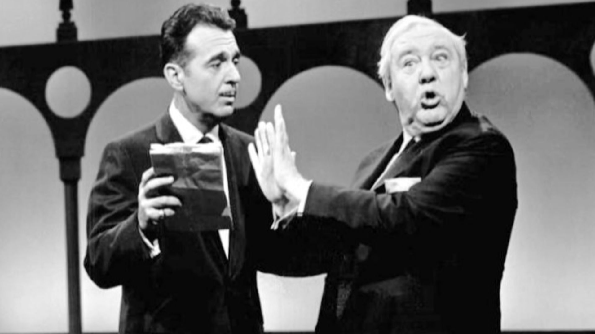 Photo of host Tennessee Ernie Ford and guest star Charles Laughton from the television program The Ford Show.  The photo shows Laughton declining to read a poem from the show's unofficial poet, Fred Wobbly.  Wobby's verses were frequently read on the prog