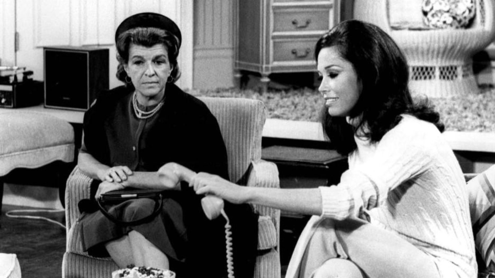 Photo of Nancy Walker as Ida Morgenstern and Mary Tyler Moore as Mary Richards from The Mary Tyler Moore Show.  In this episode, Ida, the mother of Rhoda, arrives in Minneapolis unannounced.  She has nowhere to stay when her daughter refuses to see her, s