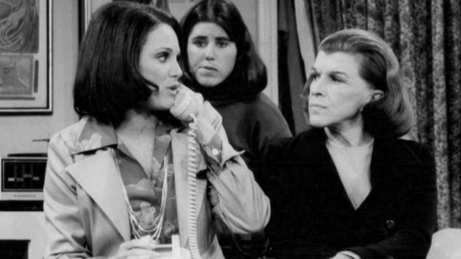 Photo from the premiere of the television program Rhoda.  Valerie Harper (Rhoda) is on phone as Julie Kavner (her sister, Brenda), and Nancy Walker (her mother, Ida), look on.