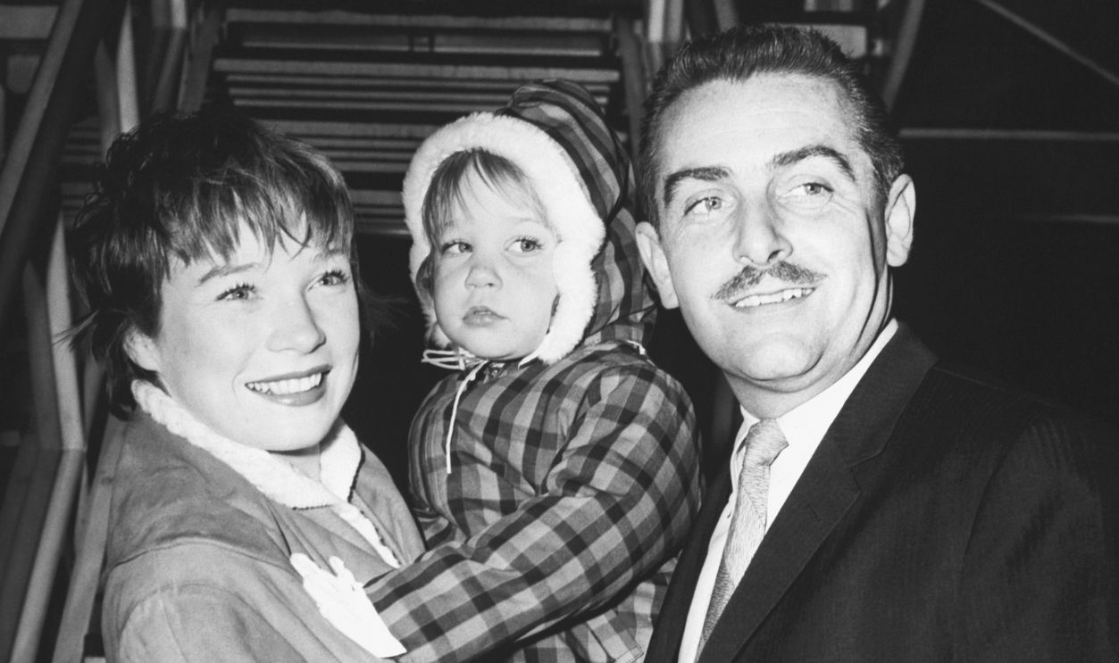 Shirley MacLaine, along with her husband Steve Parker and their daughter Stephanie, arrive at Idlewild (later JFK) airport in New York.