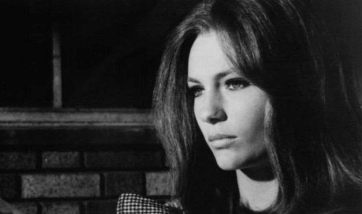 Ricky Kelman and Jacqueline Bisset looking out together in a scene from the film 'The First Time', 1969.