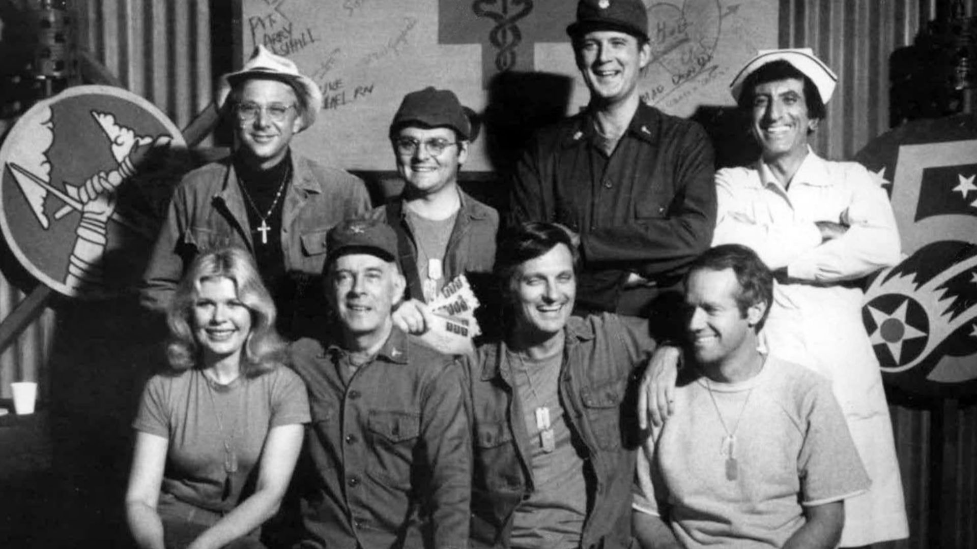 Cast photo from M*A*S*H for 1977.  Front row from left-Loretta Swit, Harry Morgan, Alan Alda, Mike Farrell.  Back row from left-William Christopher, Gary Burghoff, David Ogden Stiers, and Jamie Farr.