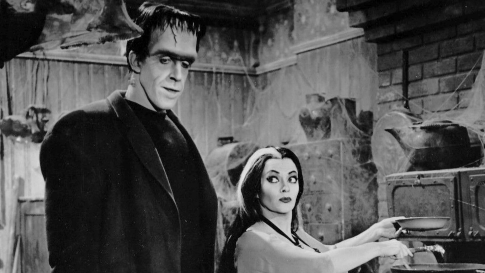 Photo of Fred Gwynne (Herman Munster) and Yvonne DeCarlo as his wife, Lily, from the television program The Munsters.