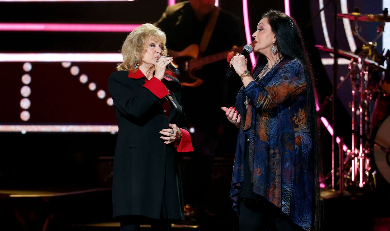 In this photo released on October 14, 2022 Peggy Sue Wright (L) and Crystal Gayle perform onstage during the 2022 CMT Artists of the Year at Schermerhorn Symphony Center on October 12, 2022 in Nashville, Tennessee.
