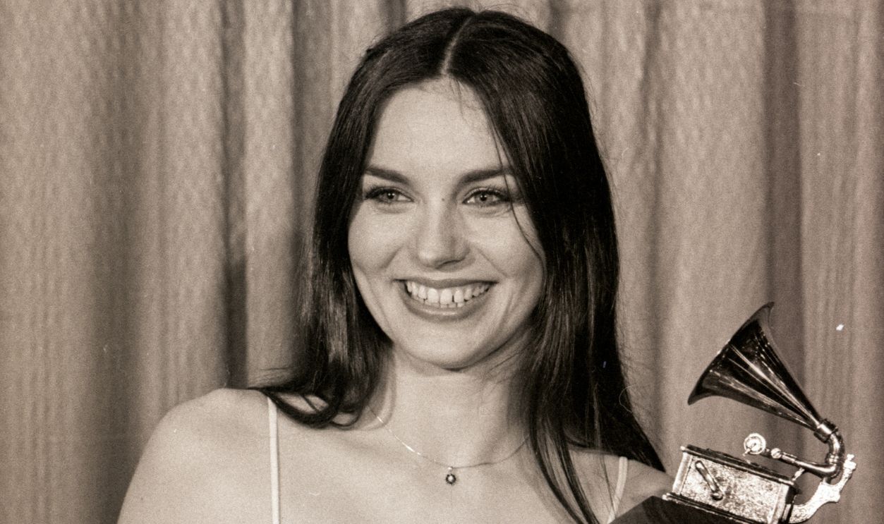 Country music singer, Crystal Gayle, is shown posing with her Grammy Award which she won at the 20th Annual awards. She won for the song