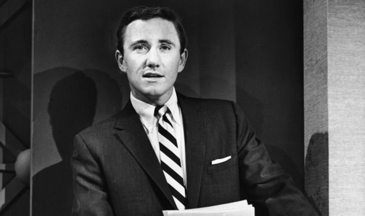 American singer, actor, talk show host, and empresario Merv Griffin holds cards in his hand and leans on the podium as he hosts the premiere episode of the game show 'Play Your Hunch' which he hosted from 1958 to 1962 on the CBS television network, New York, June 30, 1958. 