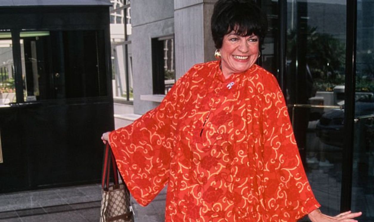 American actor and comedian Jo Anne Worley wearing a patterned red and orange trouser suit while carrying a Gucci tote bag, 1996.
