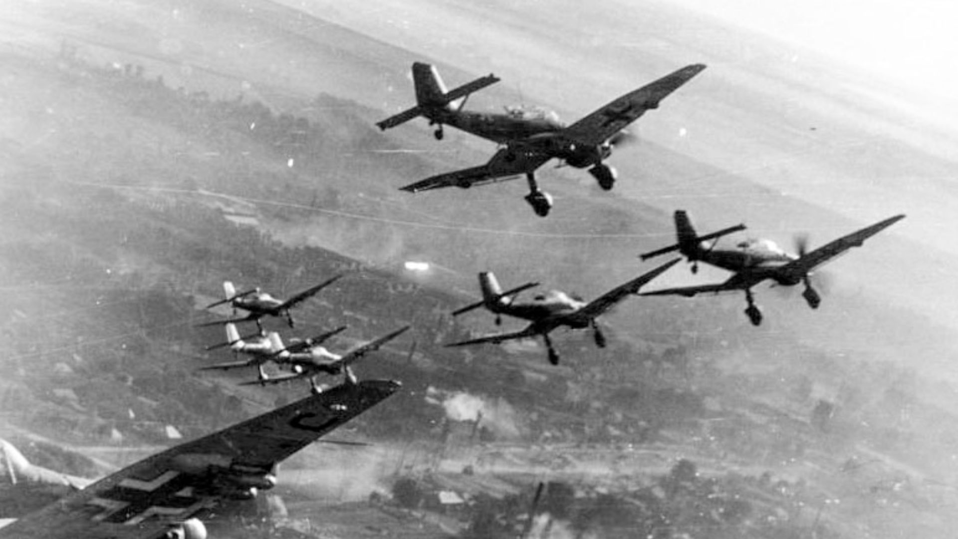 For documentary purposes the German Federal Archive often retained the original image captions, which may be erroneous, biased, obsolete or politically extreme. German Stuka dive bombers over the Eastern Front, World War II. A destroyed city is seen in th