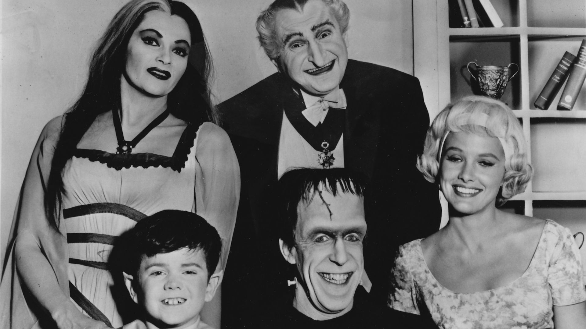 Publicity photo of television actors, (sitting; L–R) Butch Patrick, Fred Gwynne, Beverley Owen, (standing; L–R) Yvonne De Carlo and Al Lewis promoting their roles on the CBS comedy series The Munsters.