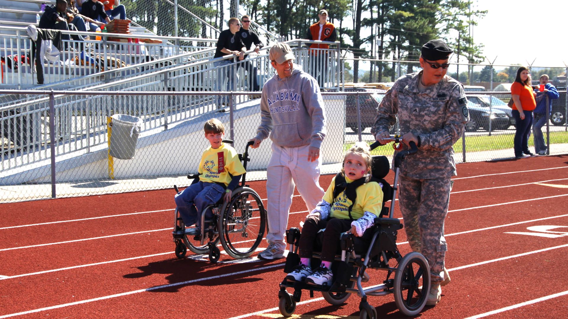 Sgt. Sophia Malone helps her athlete, Hanah Zvaiter, 11, of Rainbow Elementary School, in the assisted 50-meter wheelchair race at Special Olympics Oct. 20 in Huntsville, Ala.