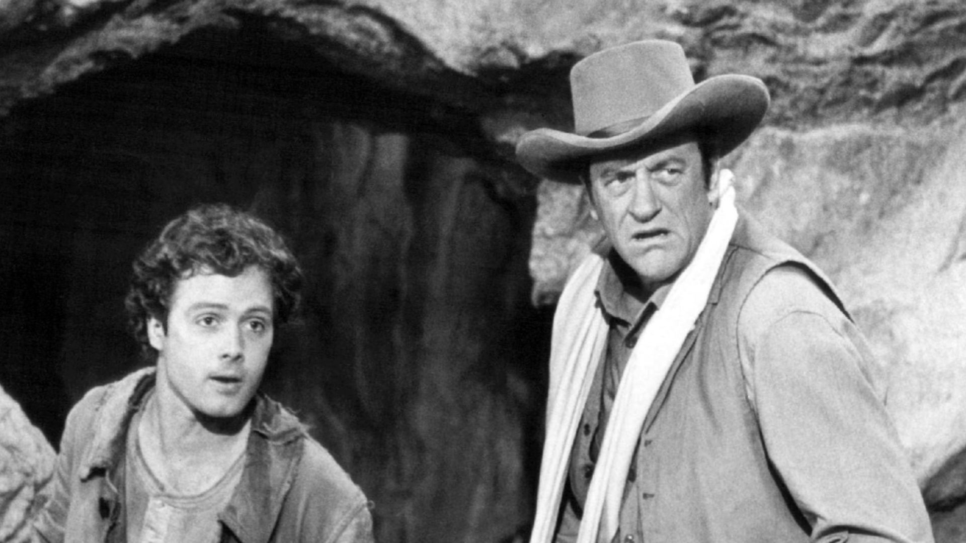 Photo from the television program Gunsmoke.  Pictured are guest star Dennis Redfield (left) as Lem and James Arness as Matt Dillon.