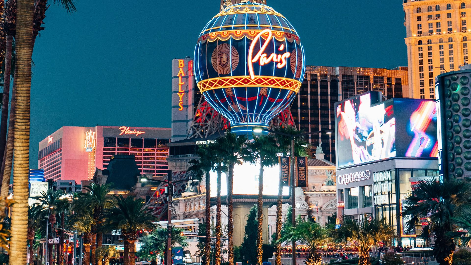 the eiffel tower in las vegas is lit up at night