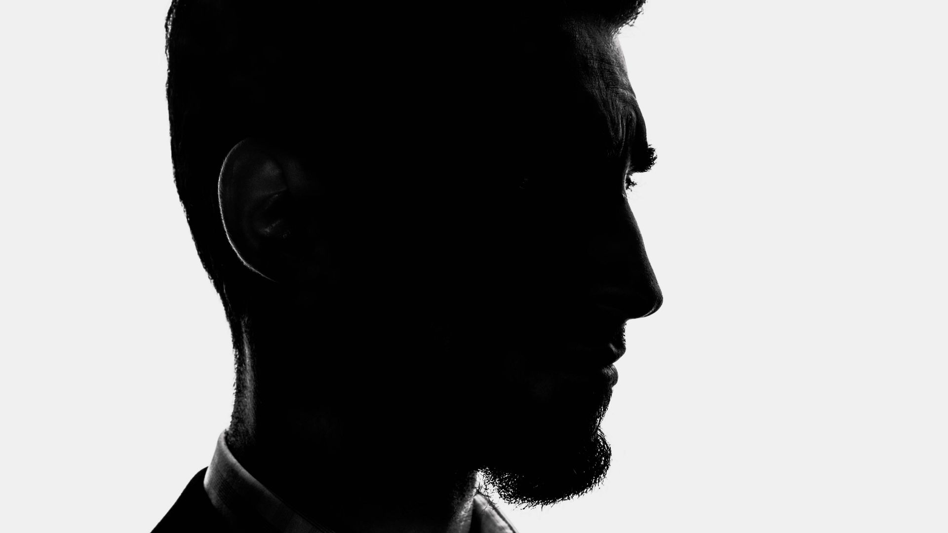 a black and white photo of a man in a suit