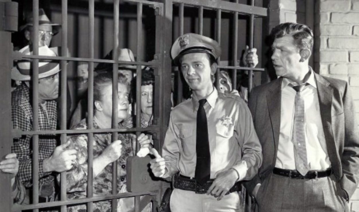 Photo from the television program The Andy Griffith Show.  When Andy returns from a trip, he finds that Barney has managed to put all of Mayberry's citizens behind bars in the town jail.