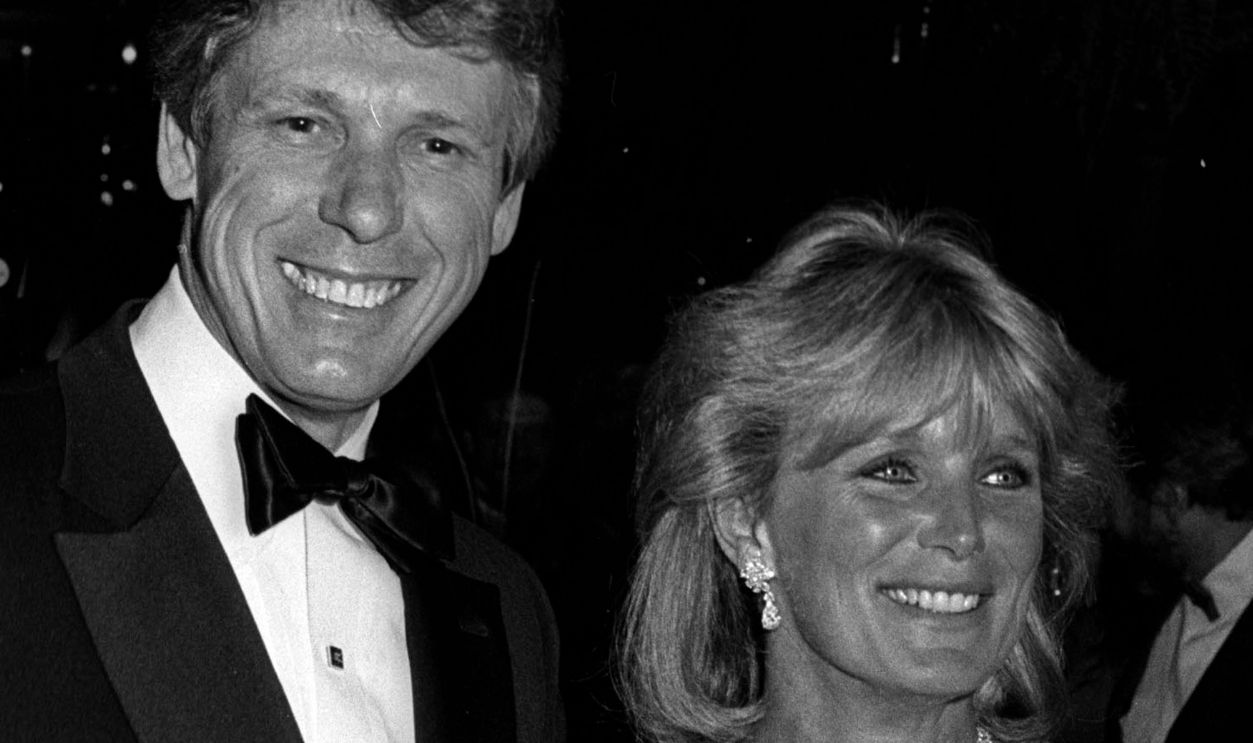 Fashion Designer Nolan Miller and actress Lisa Evans attend the party for Dynasty Fashion by Edward Lowell on April 3, 1986 at Chasen's Restaurant in Beverly Hills, California. 