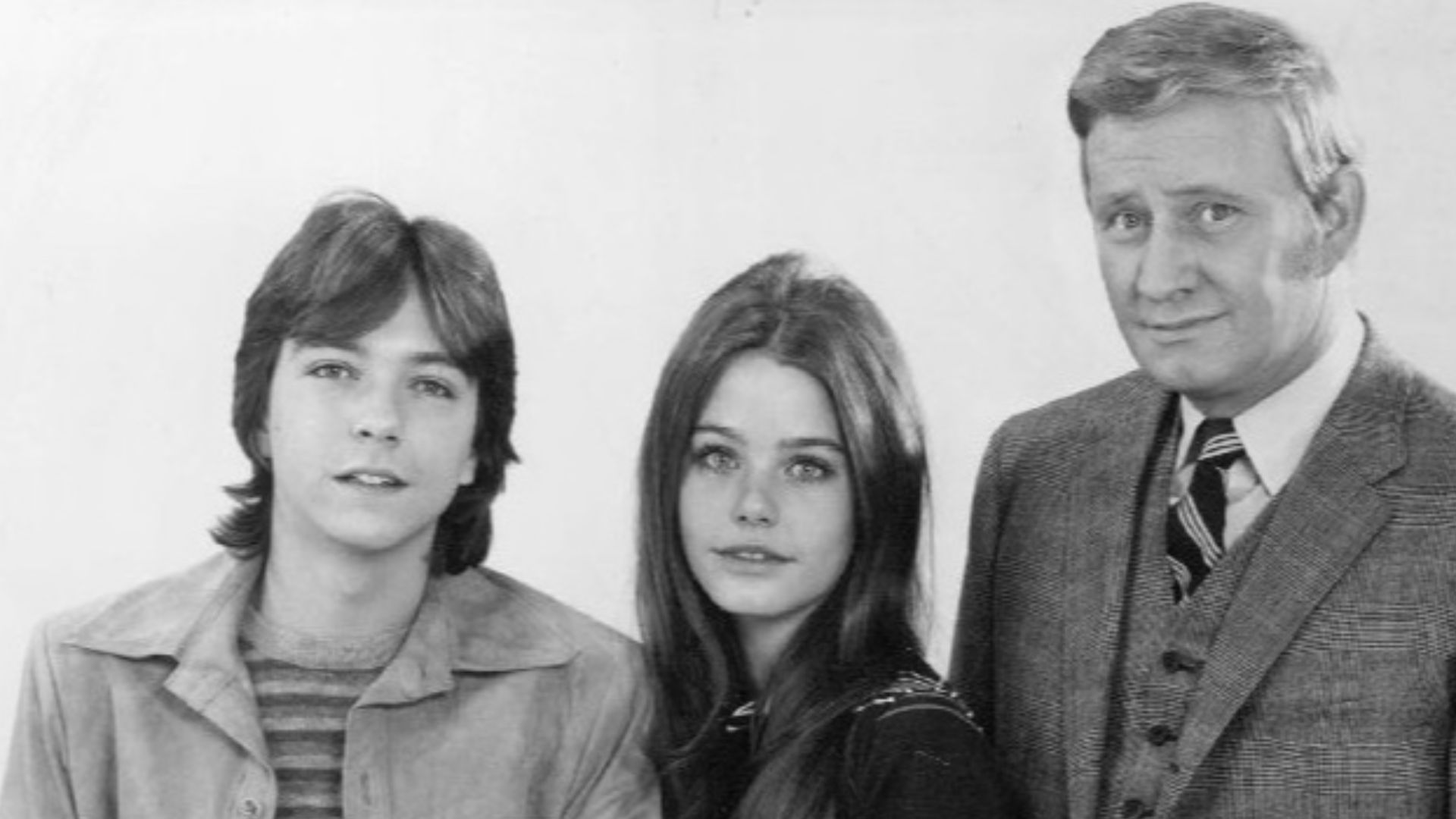 Publicity photo of television actors, (standing; L–R) David Cassidy, Susan Dey, Dave Madden, (sitting; L–R) Danny Bonaduce, Shirley Jones, Jeremy Gelbwaks, and (front; left) Suzanne Crough  promoting the ABC comedy series The Partridge Family, circa 1970.