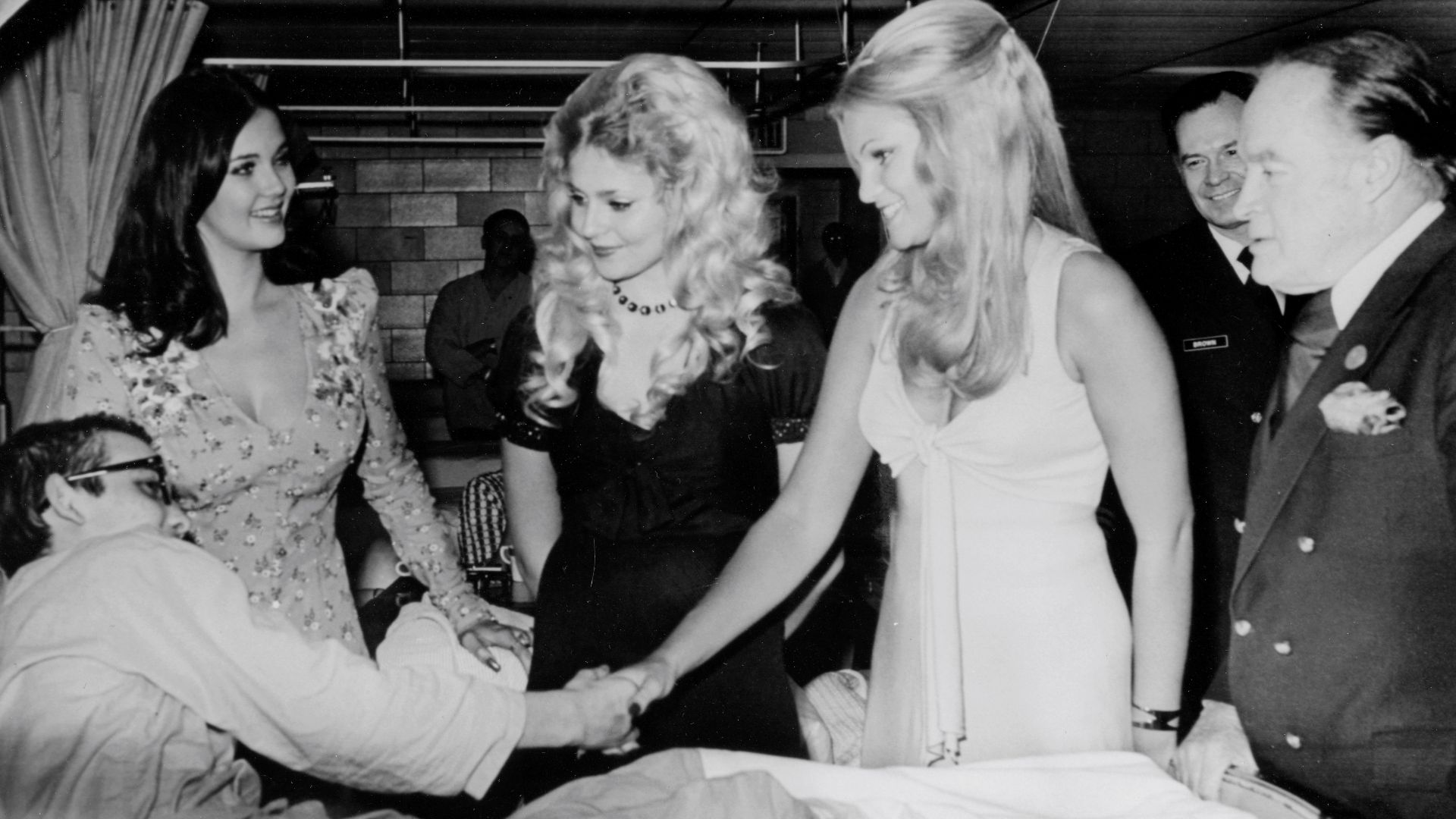 15-3001-1061
print 8x10 b&w
(left to right) Miss World - Miss USA Lynda Carter; Miss San Diego, Priscilla Barnes; and Miss Maryland, Betty Jo Grove accompany Bob Hope and spread Christmas cheer at the National Naval Medical Center, Bethesda, MD. 
Publishe