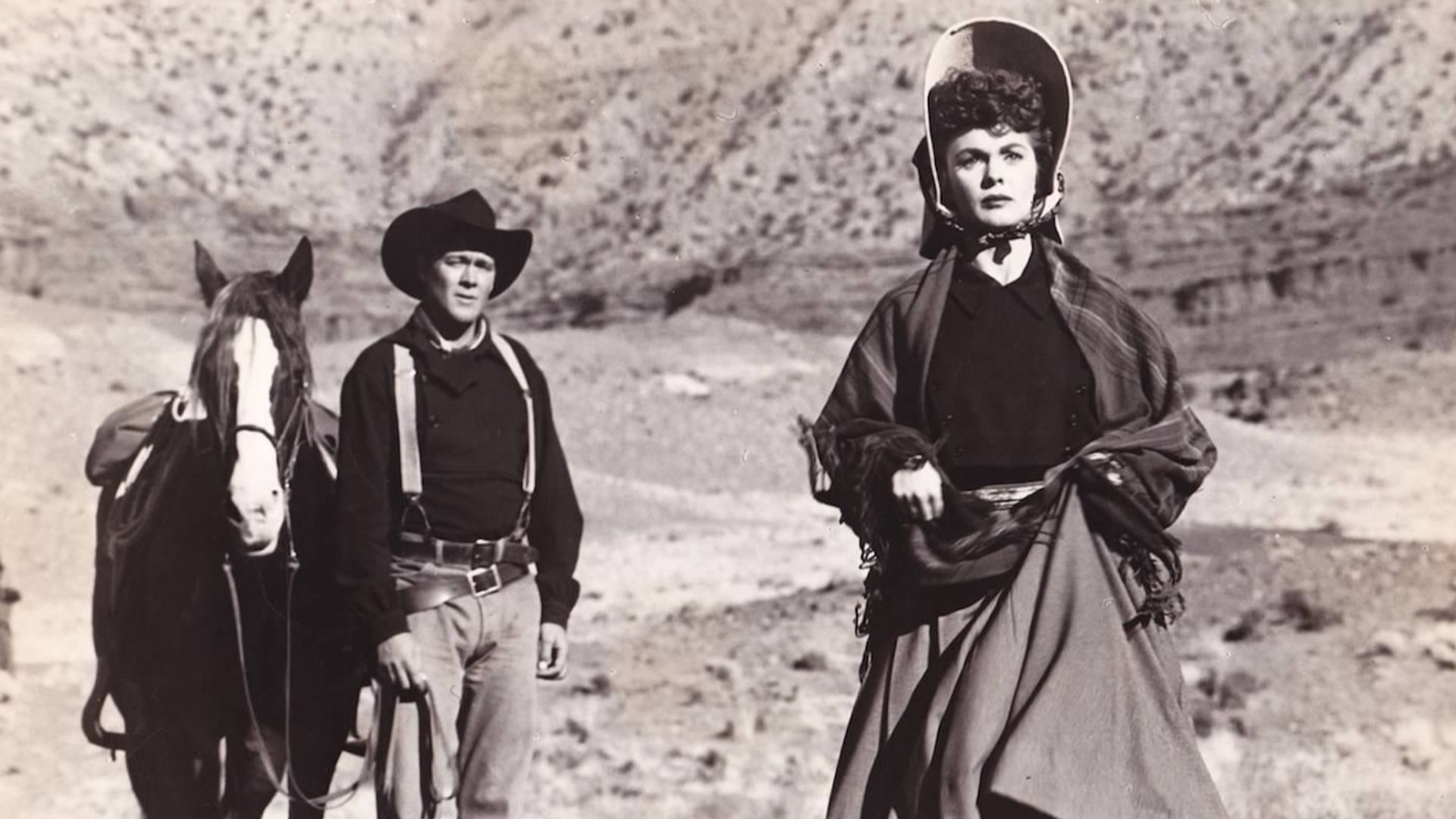 Publicity poster for the film Wagon Master (1950) showing Ben Johnson (as Travis) and Joanne Dru (as Denver). Denver is running away from Travis, who has just proposed to her.