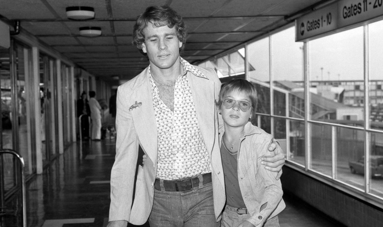American actor Ryan O'Neal with his actress daughter Tatum at Heathrow Airport where they were leaving for Rome to collect Tatum's Italian 'Oscar' for her performance opposite her father in Paper Moon.