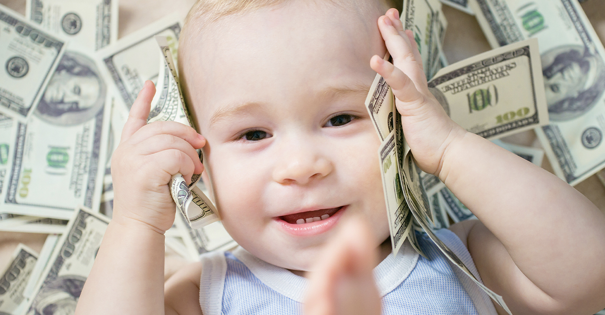 Cute hapy baby boy playing with a lot of money, american hundred dollars cash 