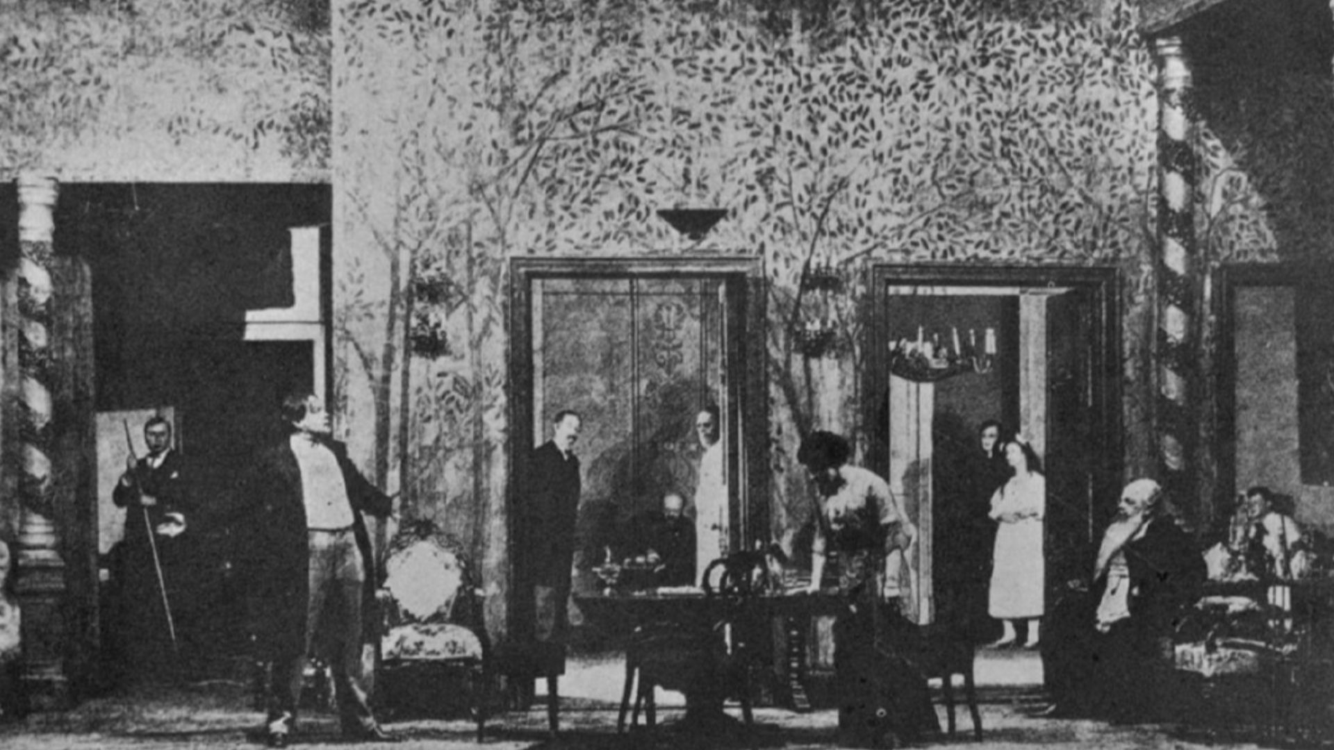 Scene from The Cherry Orchard, Moscow Art Theater.The MAT setting demonstrates a conscious attempt to avoid the stiffness and artificiality of the perfectly symmetrical box set. Variation of planes and glimpses into other rooms in the house continue the e