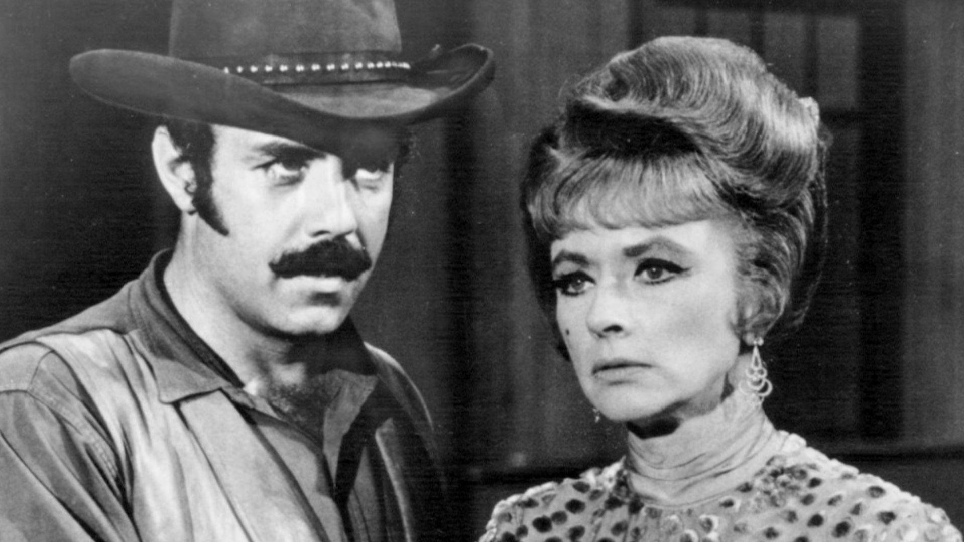 Photo of Amanda Blake as Miss Kitty and Pernell Roberts guest-starring as a hired gunfighter from the television series Gunsmoke.