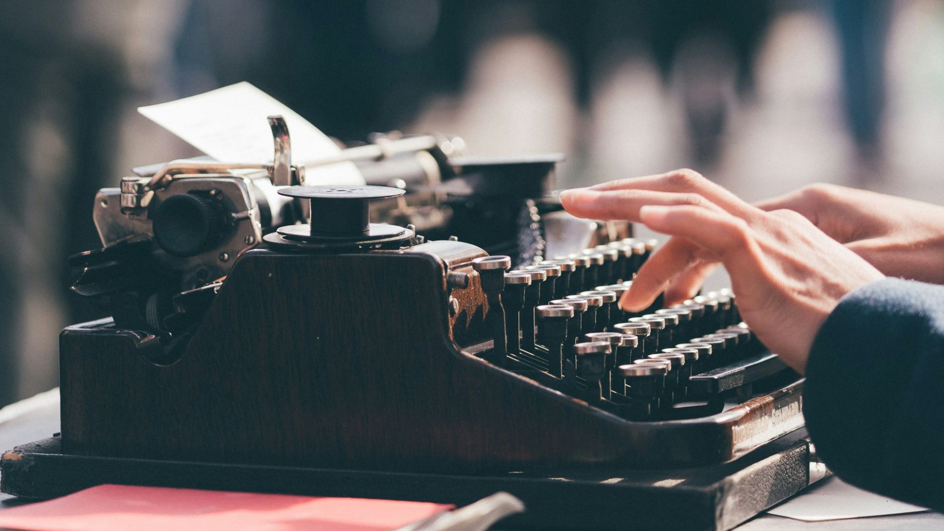 person using black typewriter