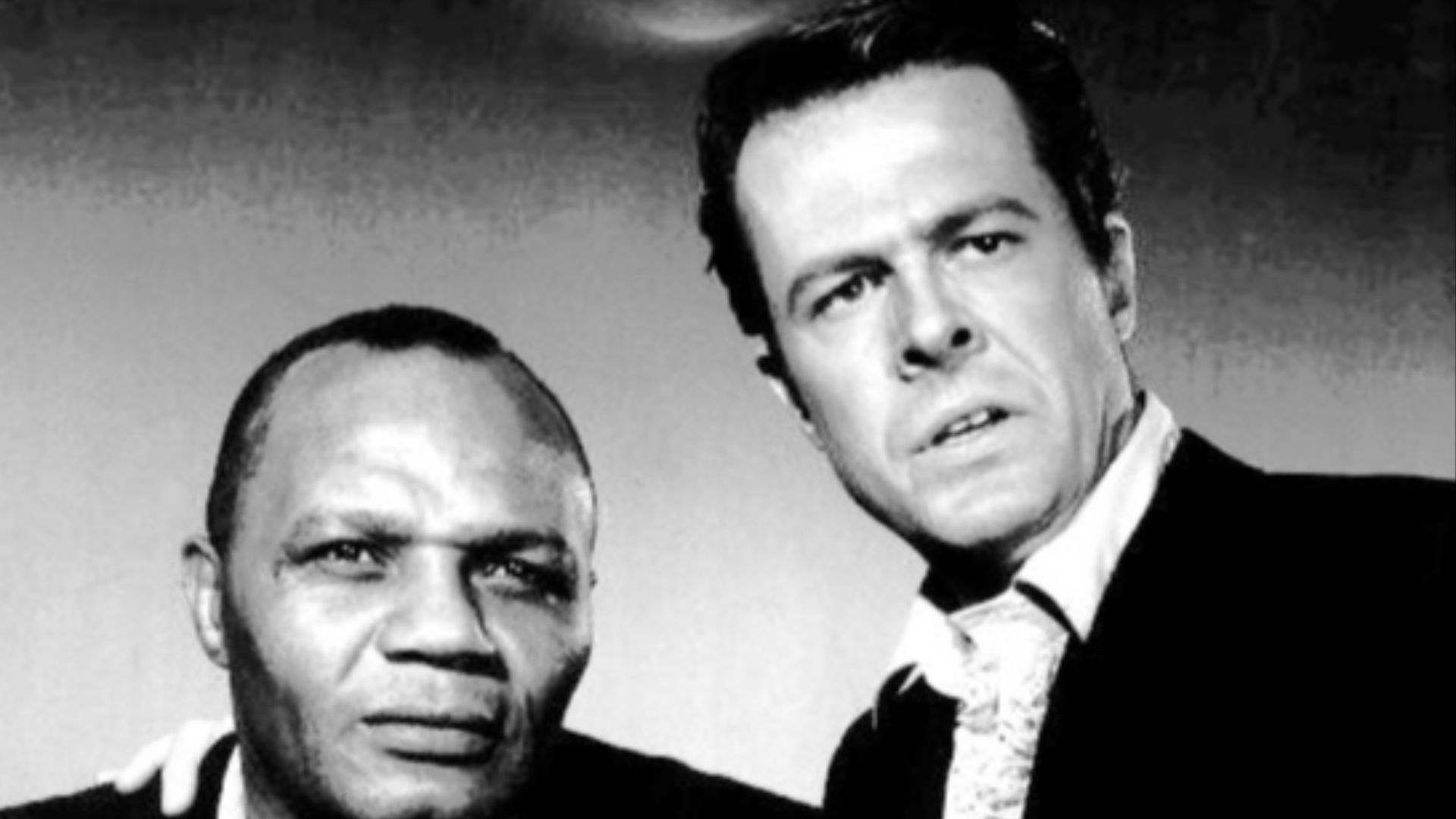 Photo of boxer Jersey Joe Walcott and Robert Culp from the television program Cain's Hundred.