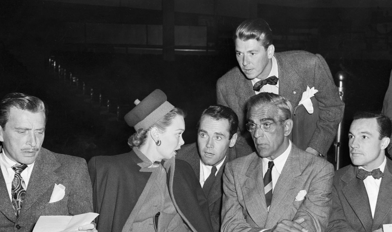 Scores of screen stars took part in a serious discussion of the film strike during an emergency meeting of the Screen Actors Guild at Los Angeles Legion Stadium Oct.3. Results will not be announced until Monday, Oct.7. Among film folk attending the mass meeting are, left to right, Jane Wyman, Henry Fonda, Boris Karloff, and Gene Kelley; Ronald Reagan is standing.