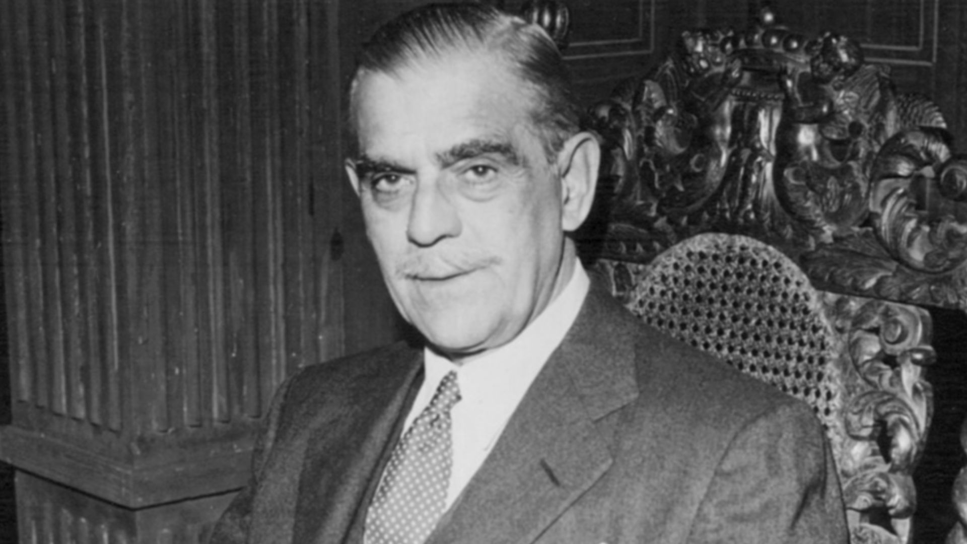 Photo of Boris Karloff from the episode The Deadly Game of the television program Suspicion.  Karloff plays a retired judge who takes in a traveler stranded by a snow storm.  He and his friends convince the stranger to participate in a mock trial they hol