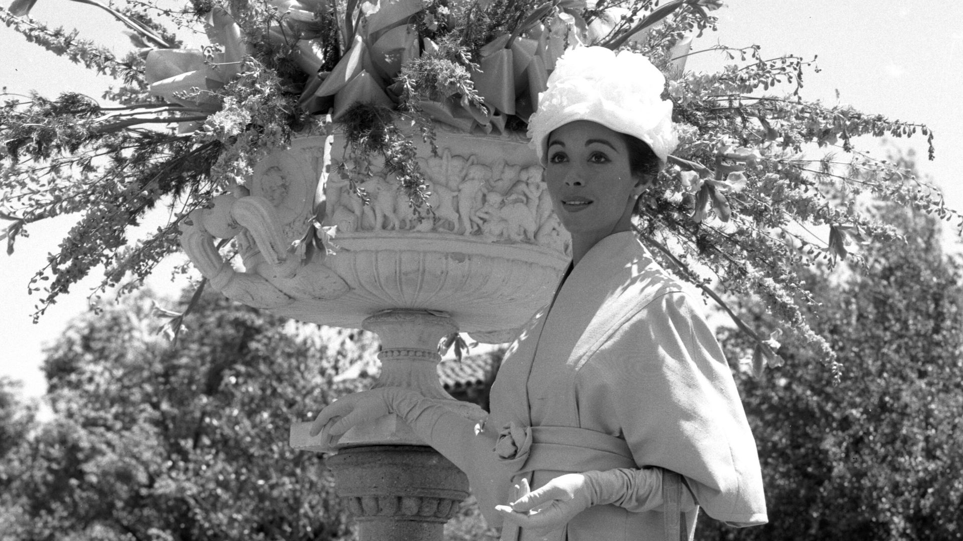 Actress Dana Wynter posing in the gardens of Dorothy Ahmanson's home in Los Angeles. She was awarded one of the ten best dressed women in Los Angeles by the Mannequins of the Assistance League of Southern California at the