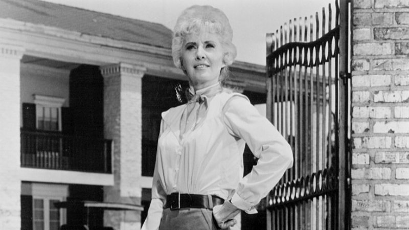 Barbara Stanwyck Big Valley in front of a house