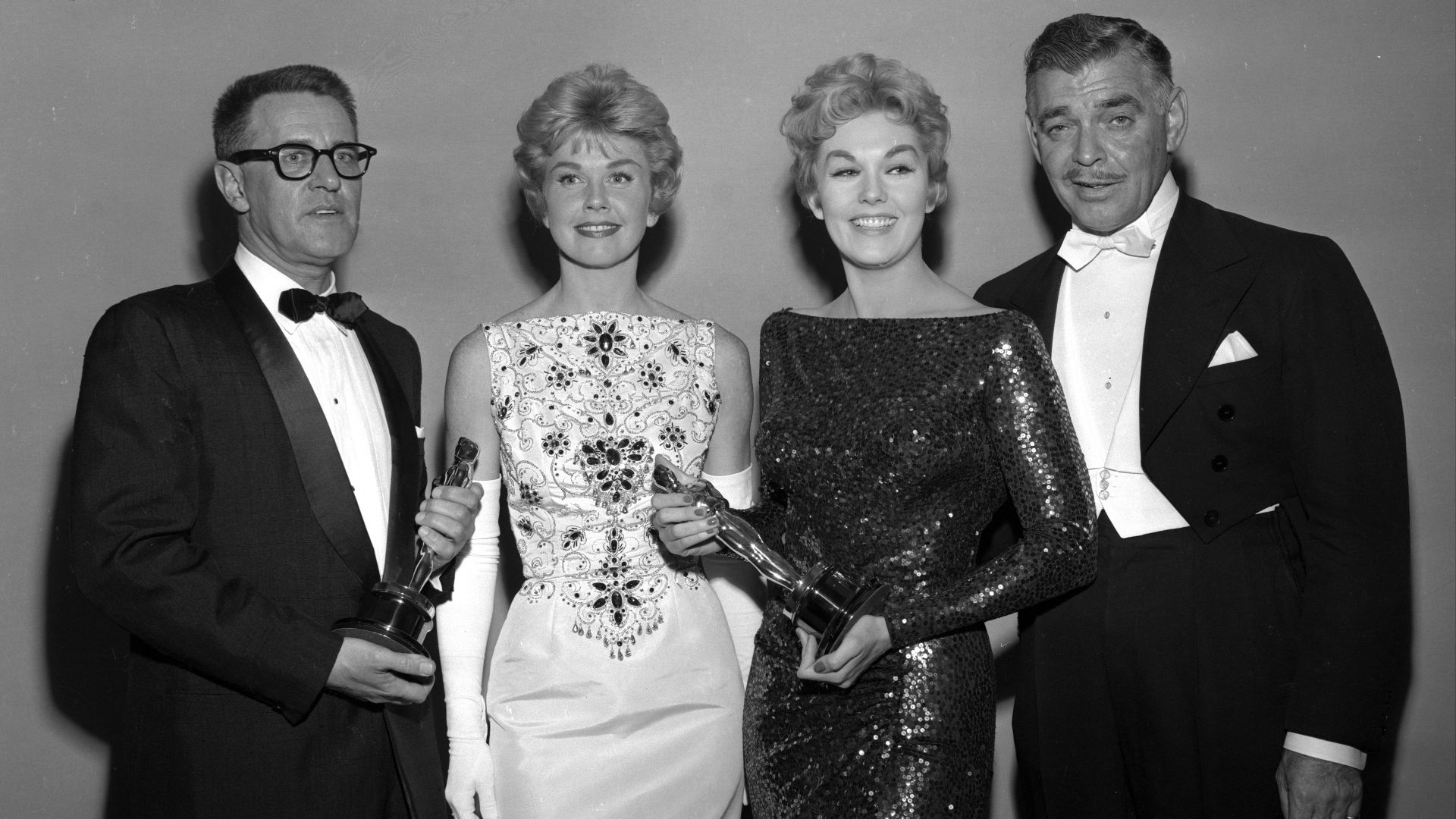 Text from newspaper caption: Writing Award--George Wells, left, receives an Oscar from Doris Day for the best story and screen-play written directly for the screen (