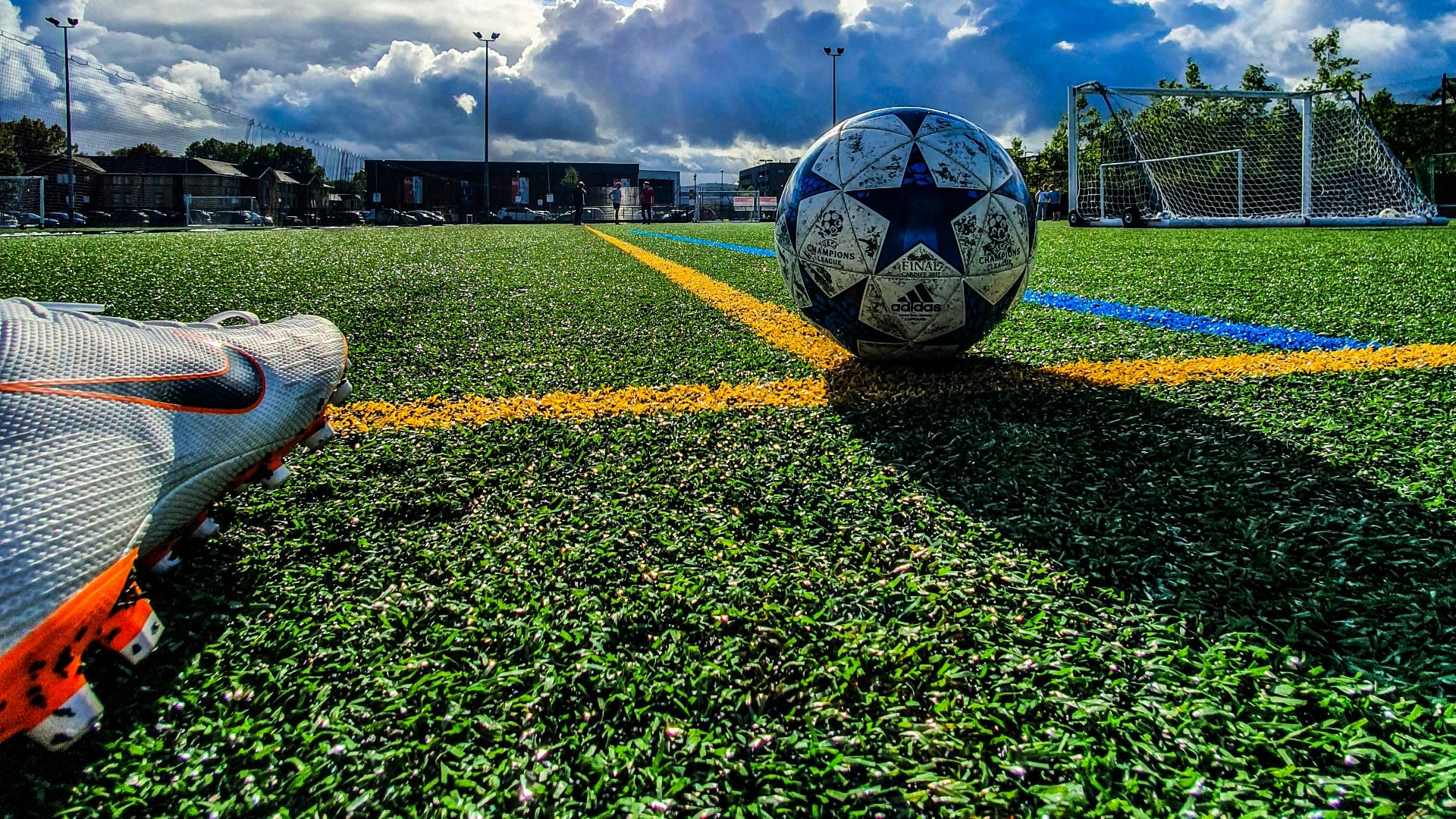 blue and grey soccer ball on green field under white and blue sky during daytime