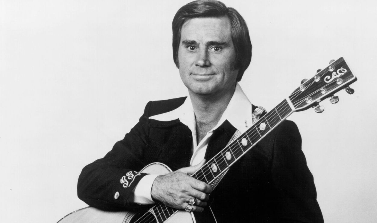 CIRCA 1976: Country singer George Jones poses for a portrait holding an acoustic guitar in circa 1976.