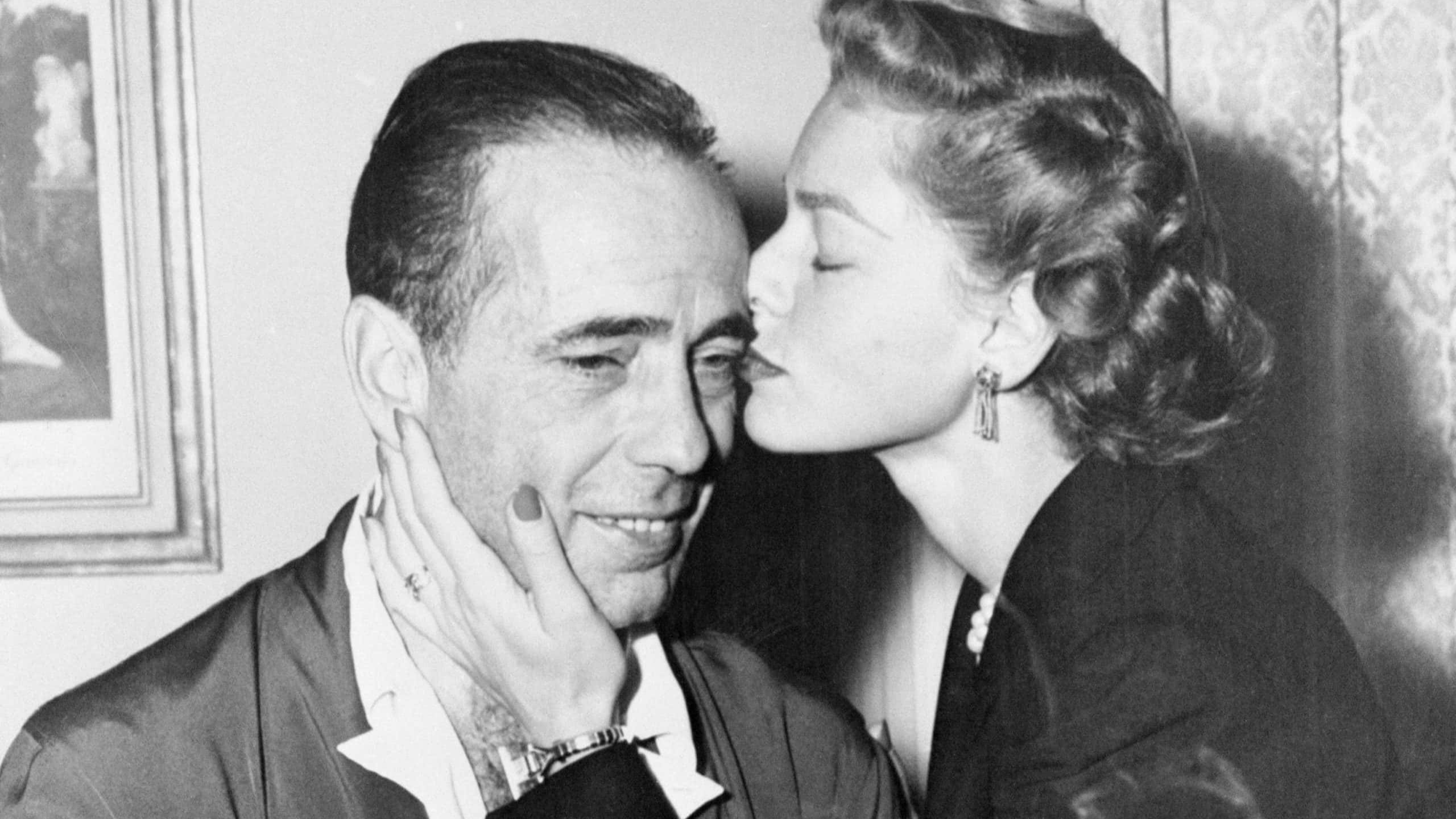 Humphrey Bogart gets a forgiving kiss from his wife Lauren Bacall