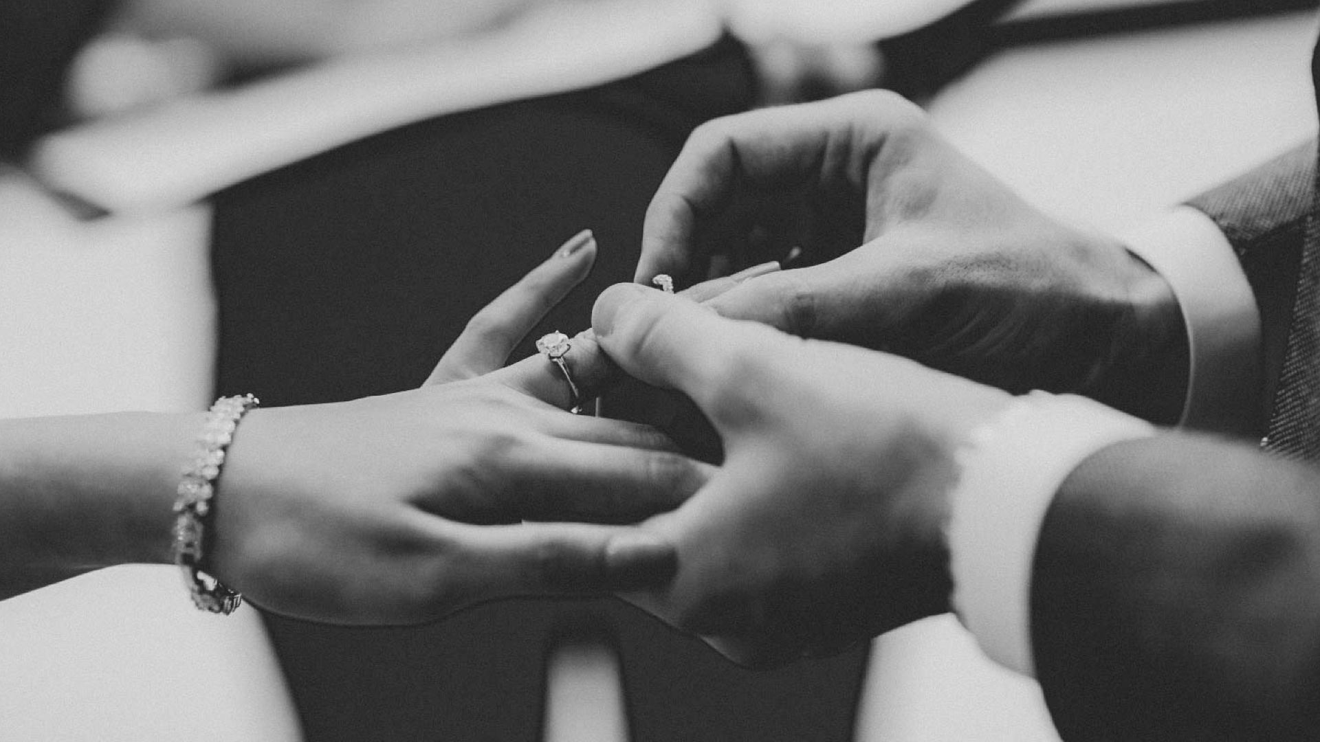 grayscale photo of person wearing ring