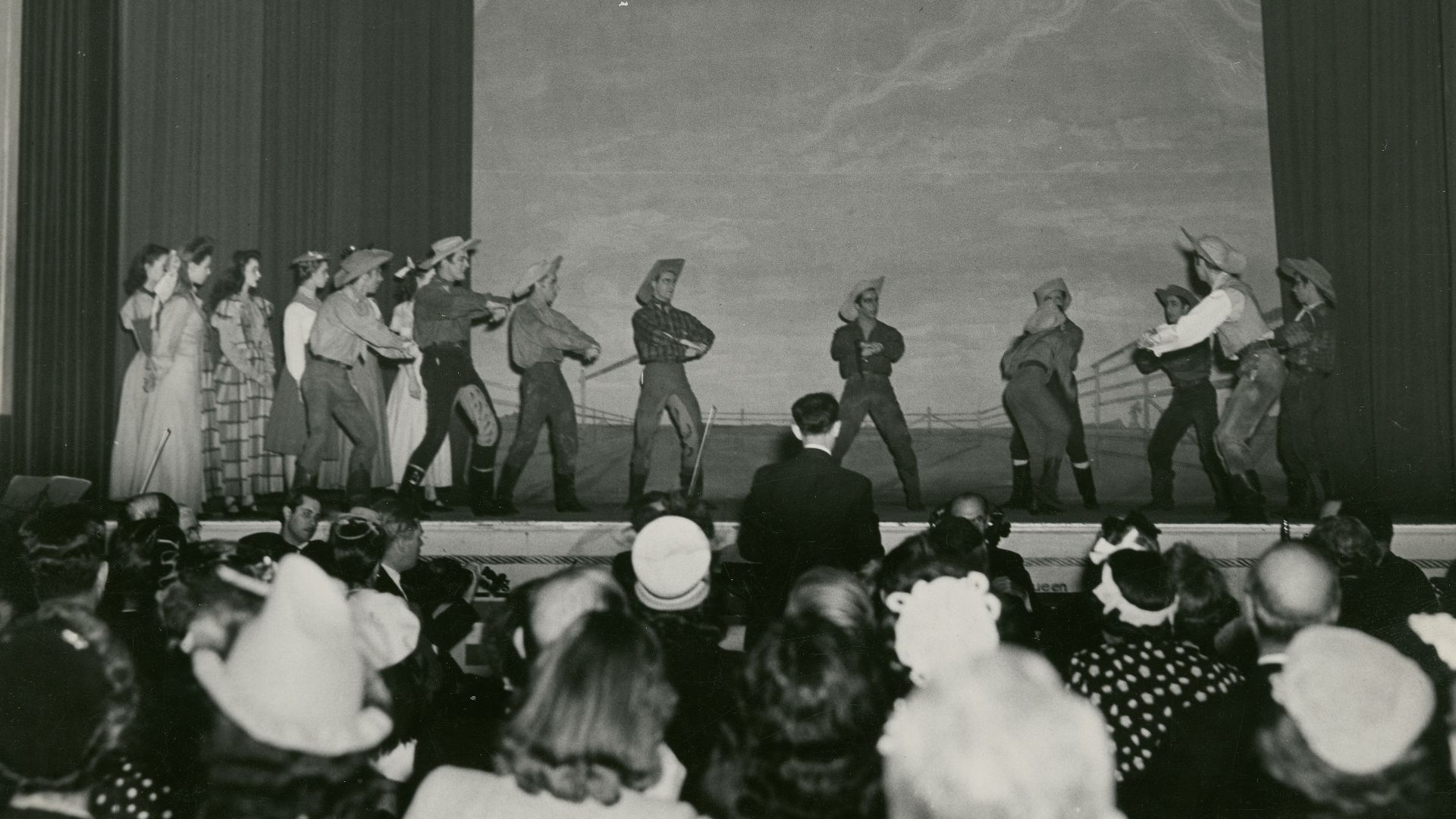 greyscale of photo people on stage