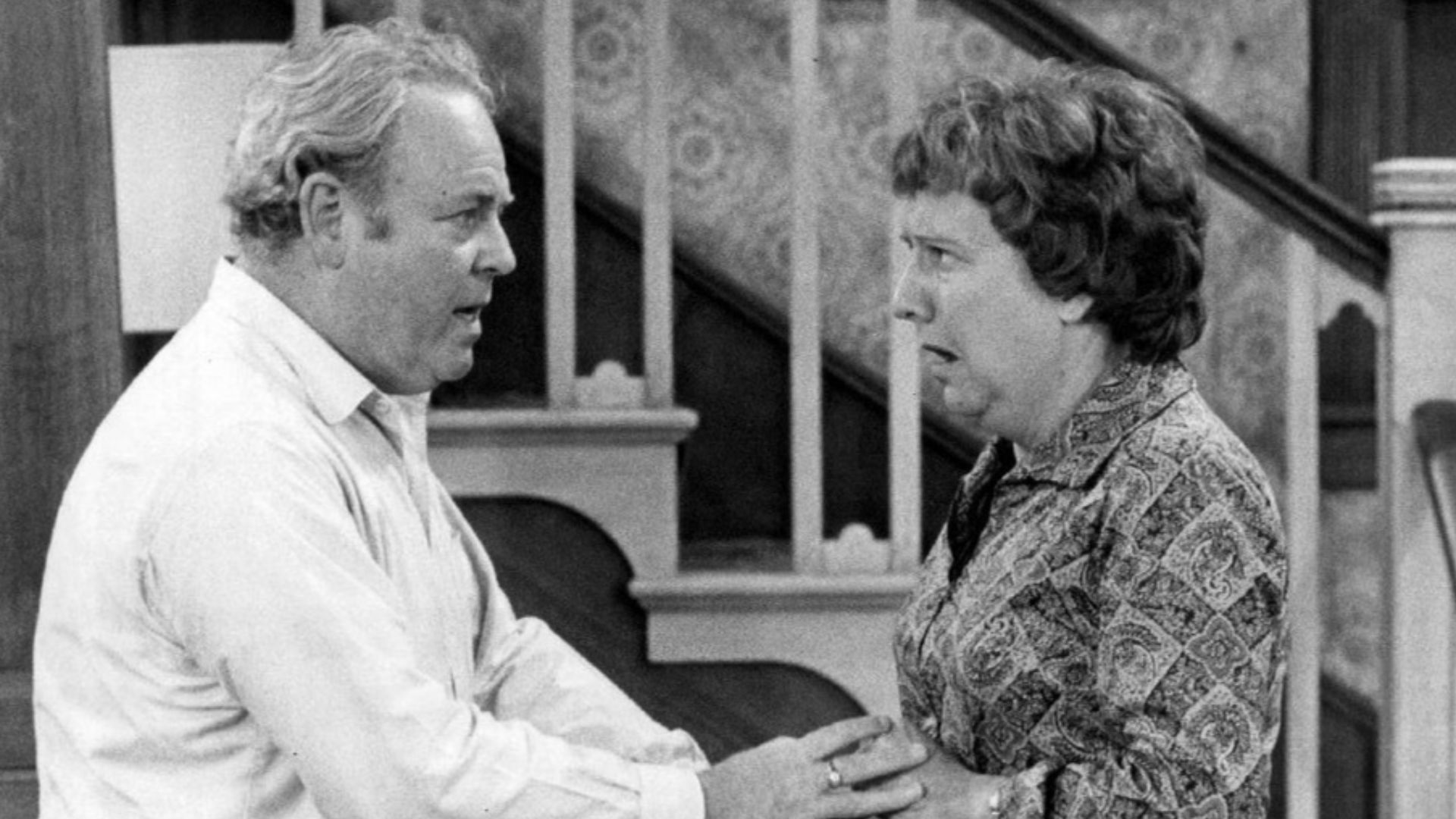Photo of Carroll O'Connor and Jean Stapleton as Archie and Edith Bunker from the television program All In the Family.  When Archie comes home in a great mood with gifts for everyone in the family, happiness turns to shock and anger when it's discovered h