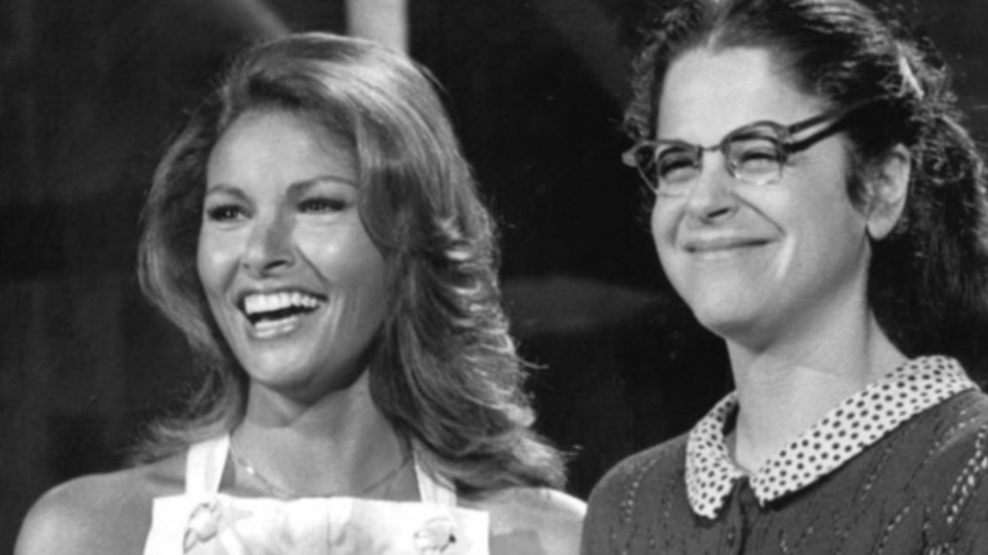 Publicity photo of Raquel Welch and Gilda Radner from Saturday Night Live rehearsal, April 24, 1976. Radner is shown as dressed as Emily Litella.