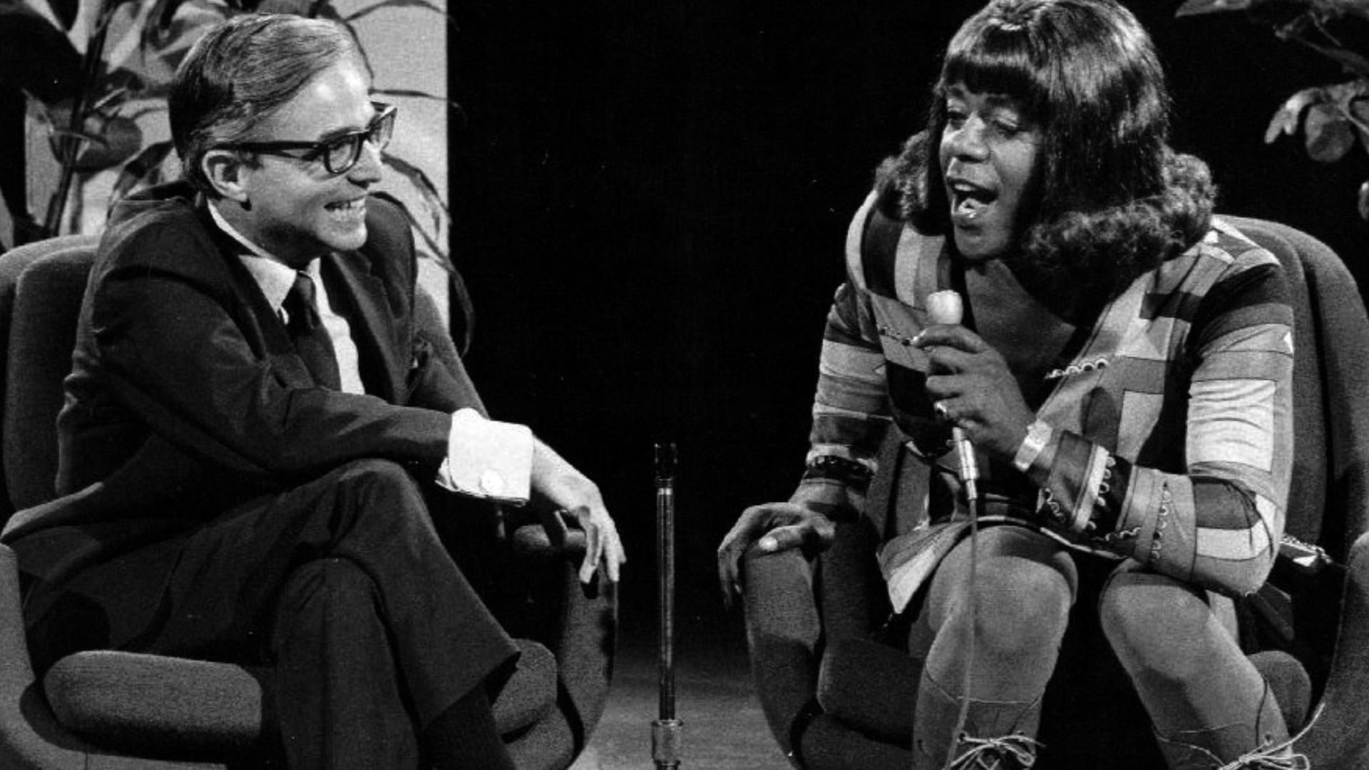 Publicity photo of Flip Wilson as Geraldine Jones from the television program The Flip Wilson Show.  Geraldine is interviewing Dr. David Reuben.