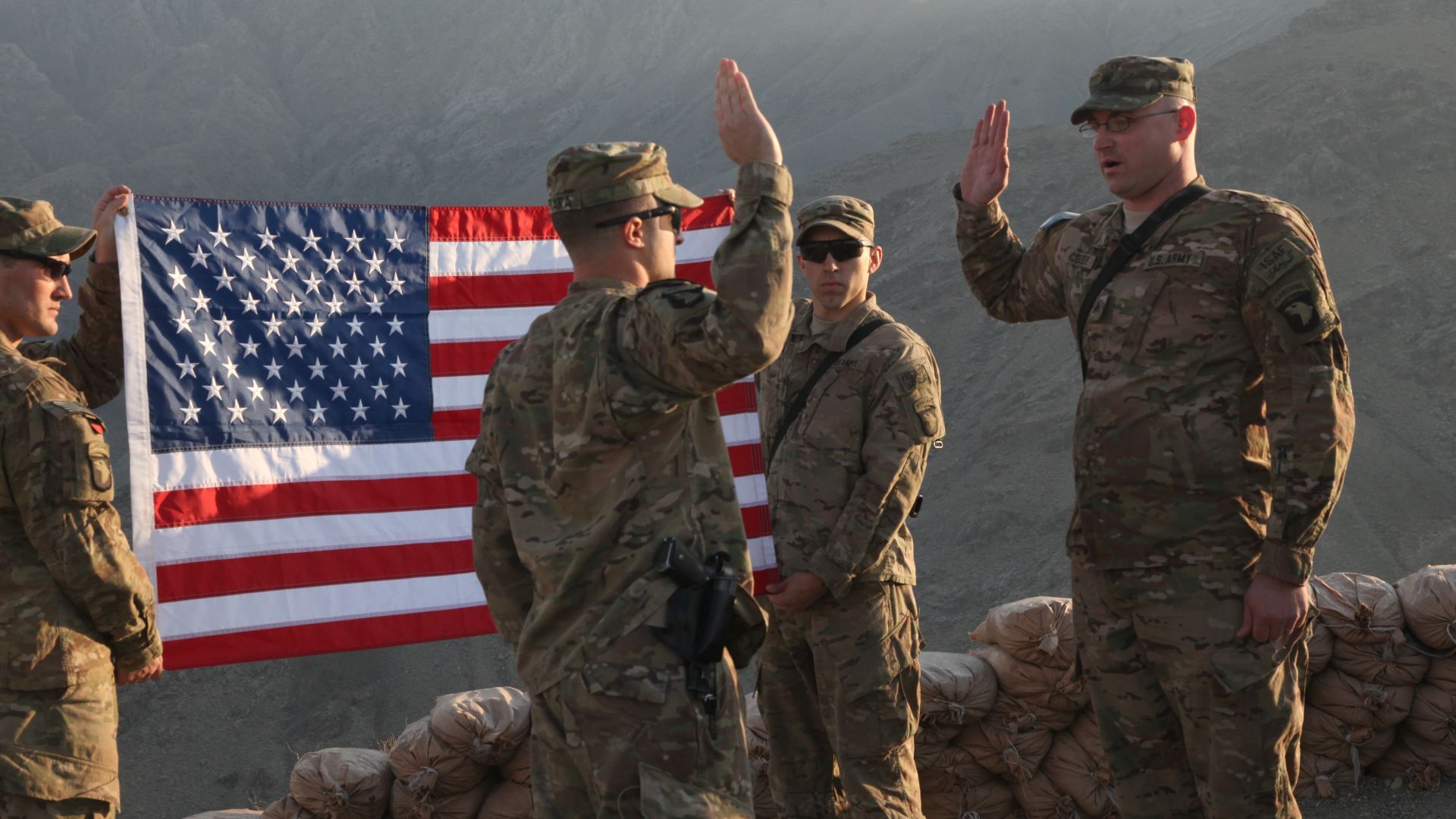 U.S. Army Sgt. Jon McGregor, right, with Delta Company, 1st Brigade, 327th Infantry Regiment, recites the oath of enlistment during his re-enlistment ceremony Jan. 22, 2013, at Torkham Gate in Nangarhar province, Afghanistan. (DoD photo by Spc. Ryan Hallg