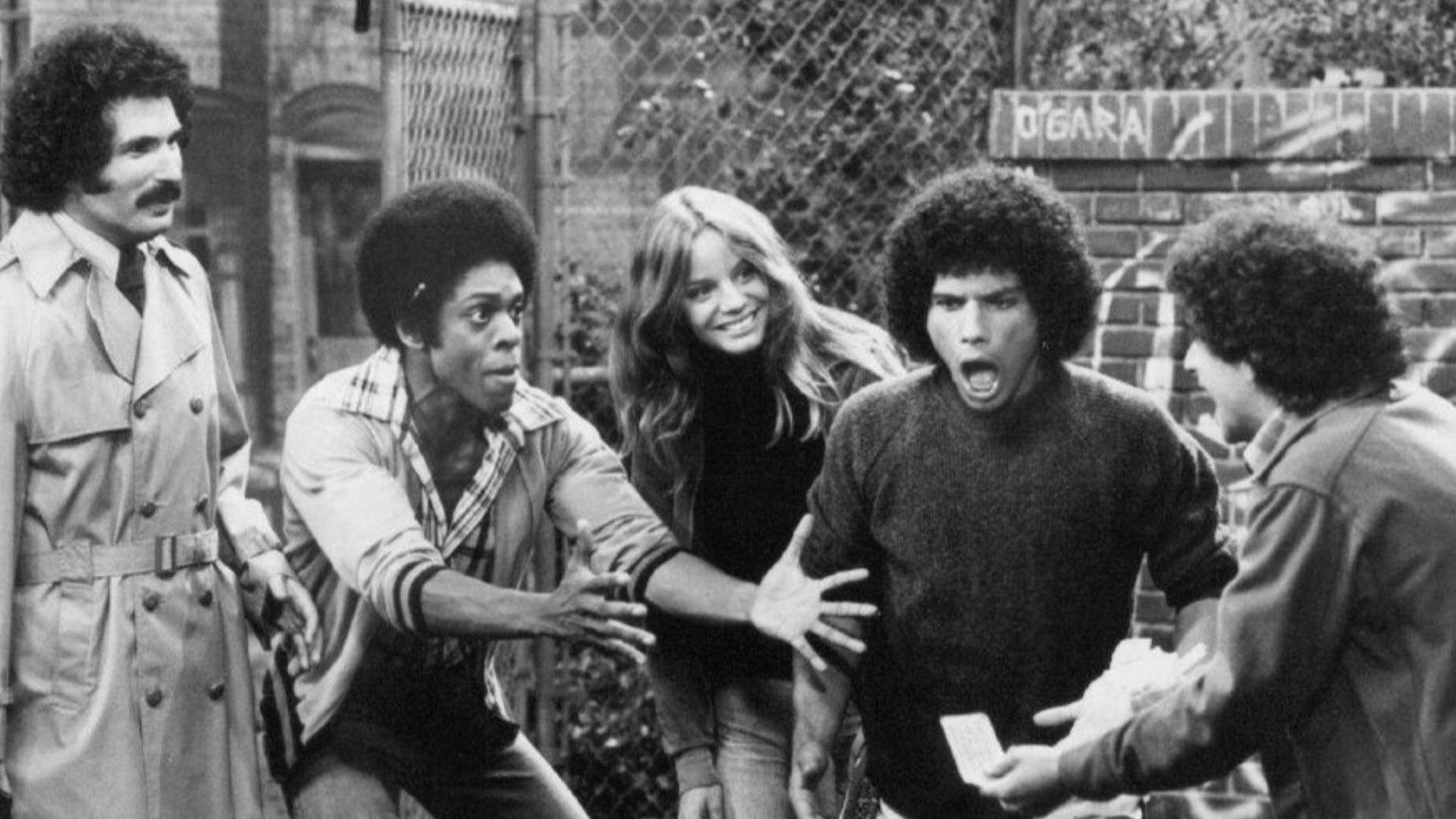 Publicity photo from the television program Welcome Back, Kotter. From left: Gabe Kaplan, Lawrence Hilton-Jacobs, Wendy Rastatter, Robert Hegyes, and Ron Palillo.  The Sweathogs are celebrating a winning New York State lottery ticket while Mr. Kotter look