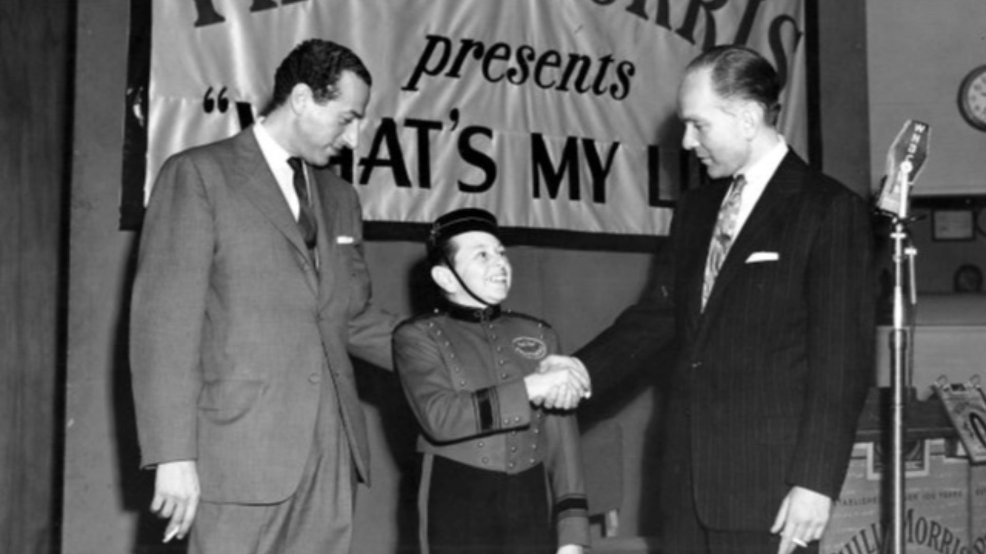 Photo of Mark Goodson, Johnny Roventini and Bill Todman from a 1952 radio version of What's My Line?.  The program's sponsor was Phillip Morris and Roventini was their spokesman in the character of Johnny the bellboy.