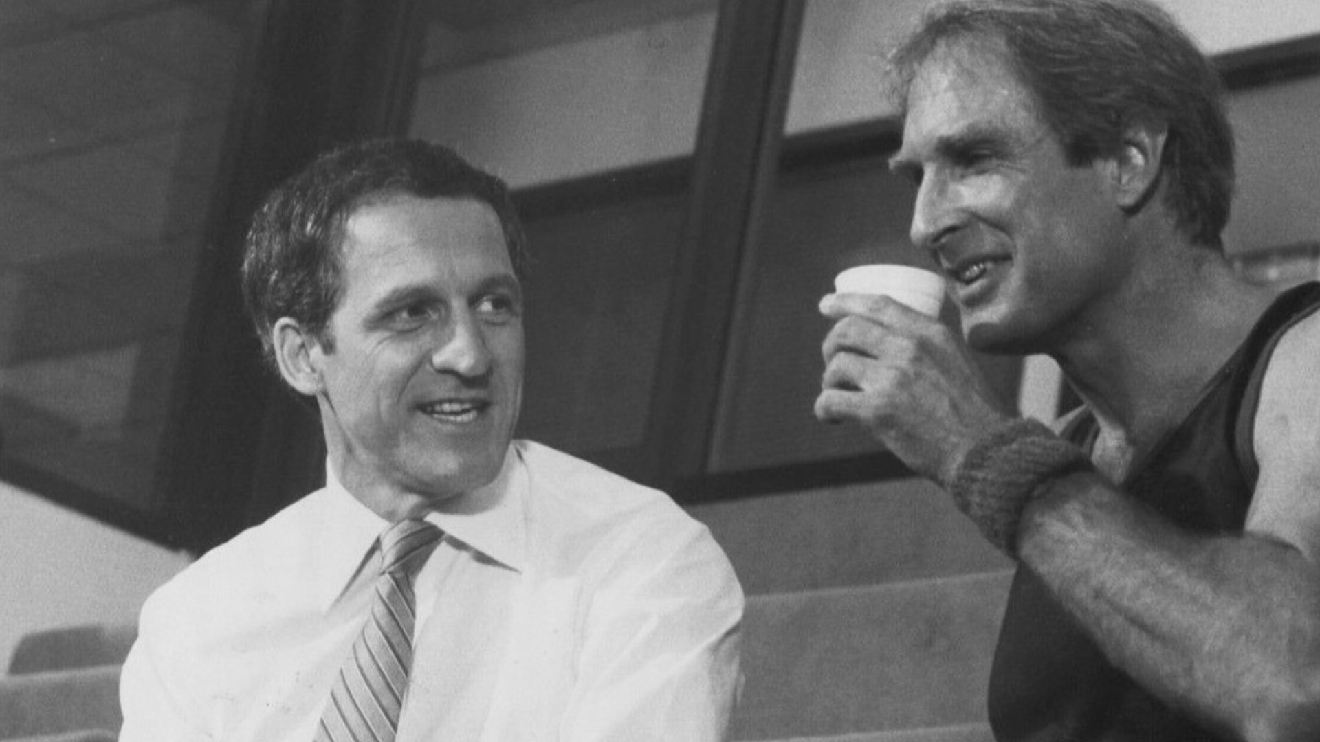COFFEE AND CONFRONTATION--A battle looms behind the smiles and the coffee cup as Captain Furillo (Daniel J. Travanti, left) threatens to expose of politically sensitive police cover-up when he stands toe-to-toe with Chief Daniels (Jon Cypher) in